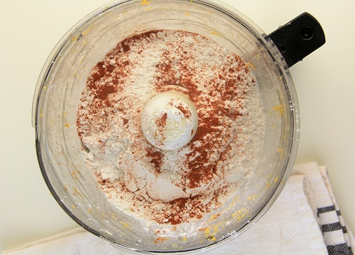 Flour and cayenne pepper in the bowl of a food processor.