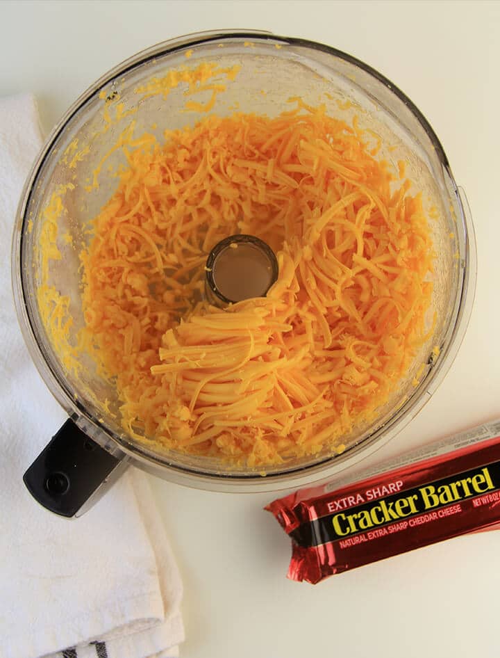 Grated cheese in bowl of food processor.