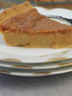 A plate with a slice of chess Pie which is an old-fashioned Southern favorite custard-type pie made from a few simple ingredients. It's easy and everyone loves it!