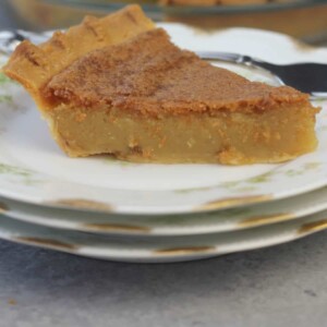 A plate with a slice of chess Pie which is an old-fashioned Southern favorite custard-type pie made from a few simple ingredients. It's easy and everyone loves it!