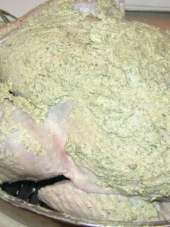Herb butter slathered on a turkey ready for roasting.