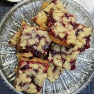 Raspberry shortbread bars on a silver platter.