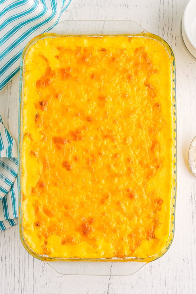 Overhead photo of a dish of baked mac and cheese on a white board background.