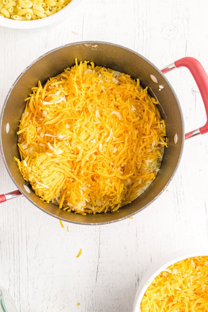 Grated cheese in a pot for macaroni and cheese.