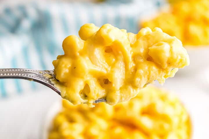 A fork with a bite of mac and cheese.