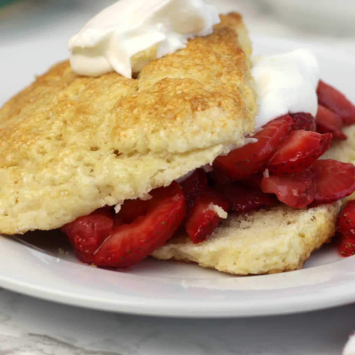 Strawberry shortcake recipe with easy, homemade biscuits using cream and brown sugar.