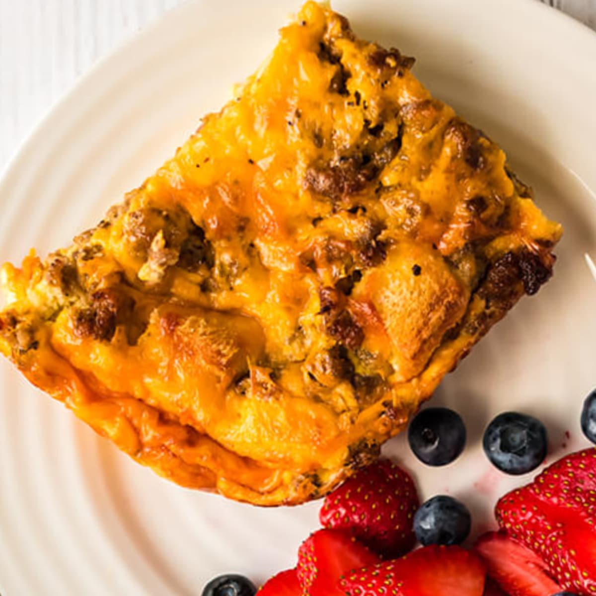Overnight breakfast casserole that you can whip up in about twenty minutes, stick in the fridge, and bake in the morning. This one features sausage and egg, with lots of cheese!