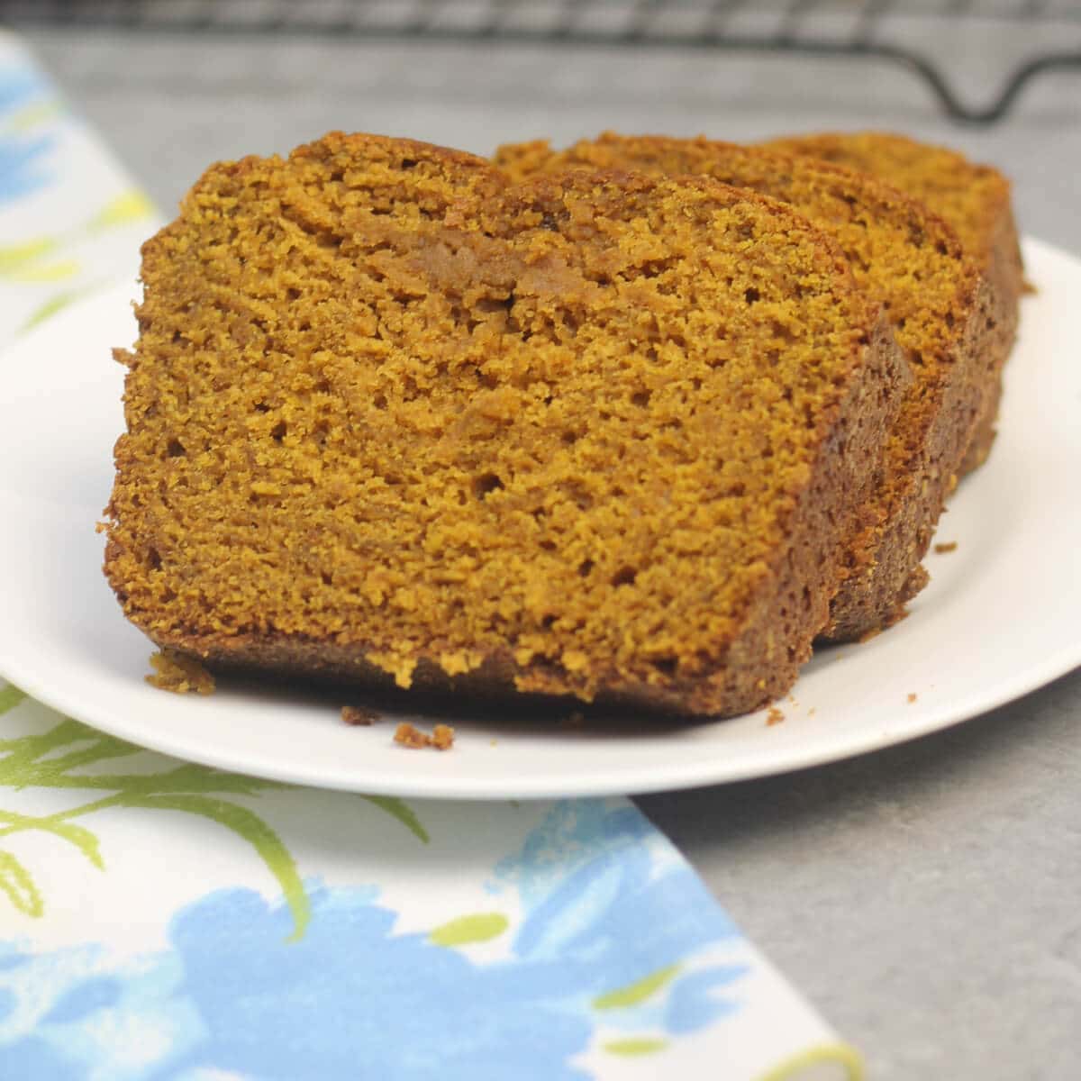 Slices of pumpkin bread on a white plate.