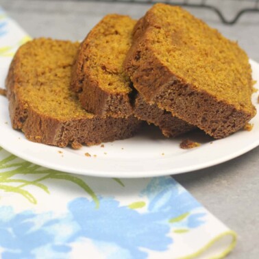Slices of pumpkin bread on a white plate.