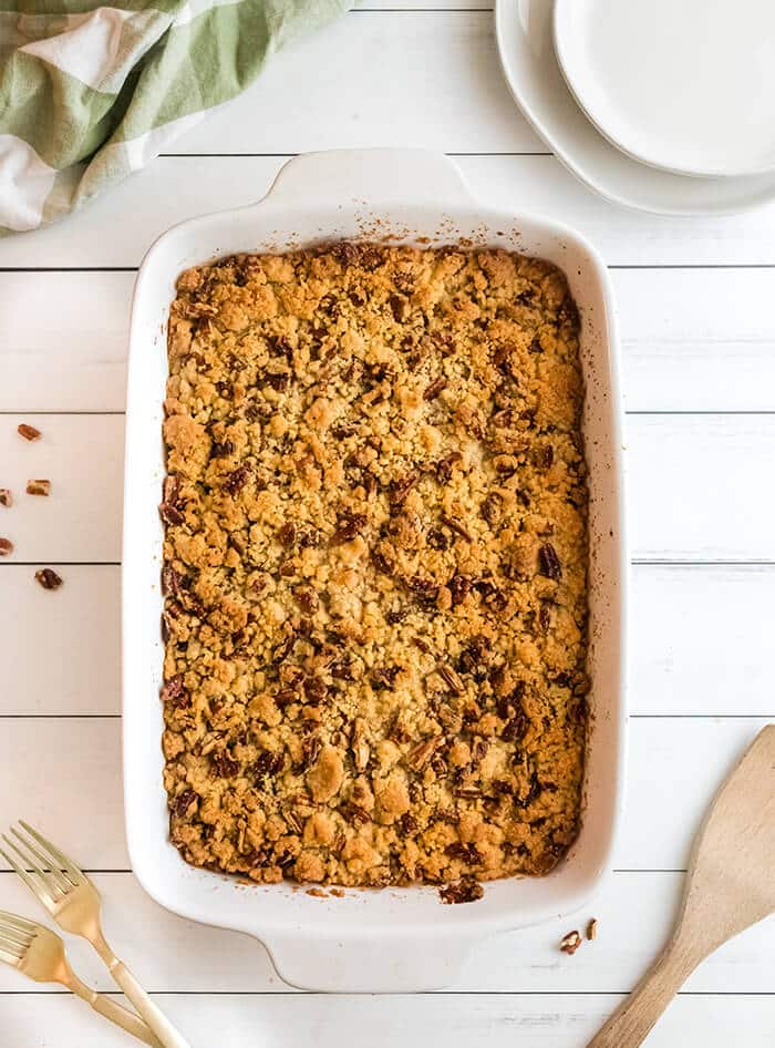 White casserole dish of baked sweet potato casserole.