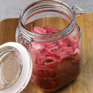 A jar of pickled red onions ready to store.