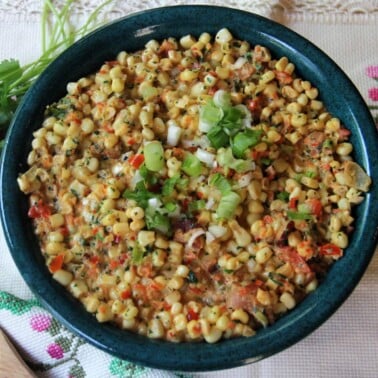 Jalapeno creamed corn with bacon, scallions, and cilantro is a great side dish for taco night, burgers on the grill, or slow-roasted pork. This cream style corn is a little spicy and everyone loves it!