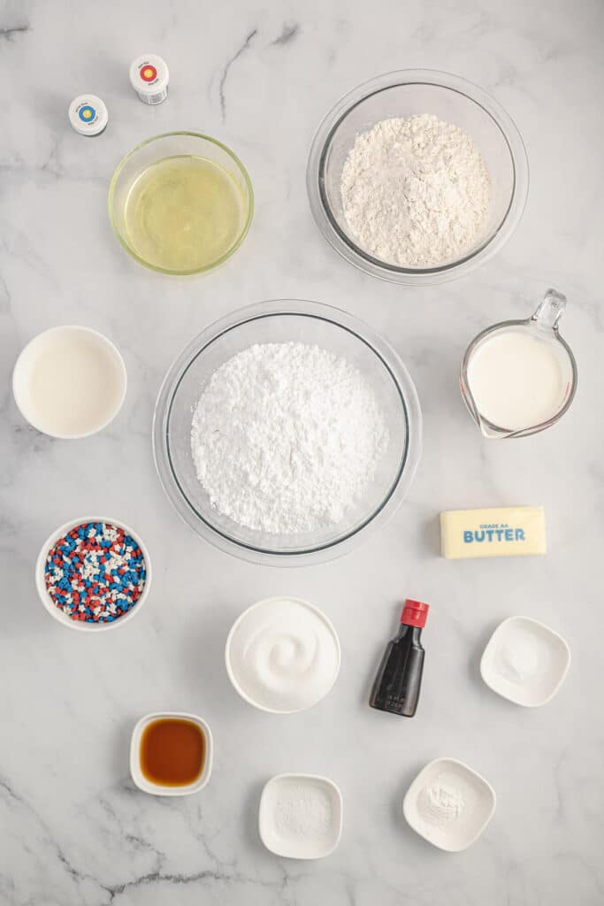 Ingredients for 4th of July cupcakes spread out on the marble counter.