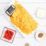 Grated cheese, pimentos, cayenne pepper, and mayonnaise ready to make pimento cheese.