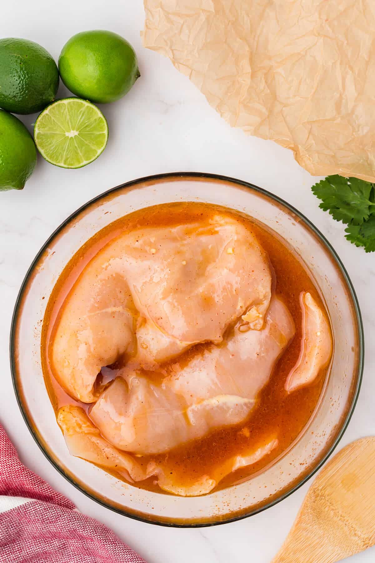 raw chicken in a bowl with marinade