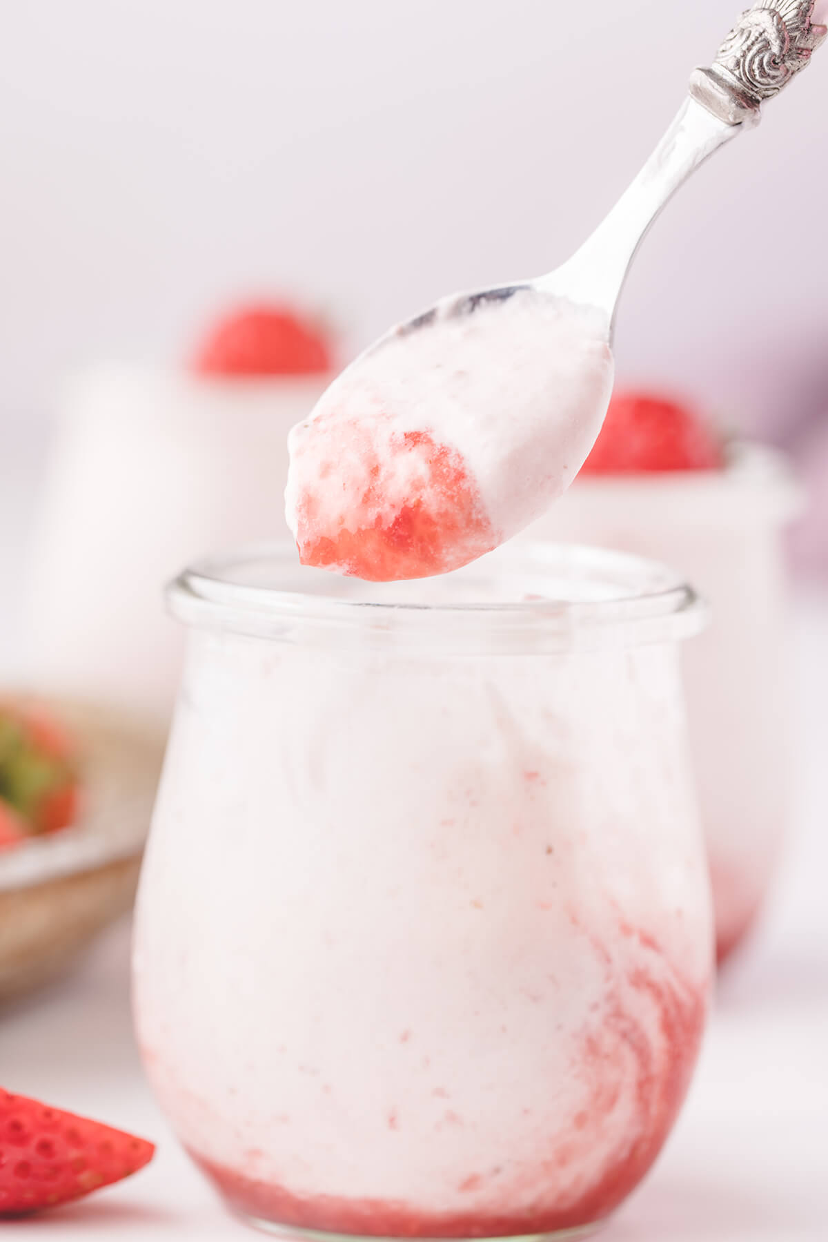 a spoon full of strawberry mousse showing the light fluffy texture