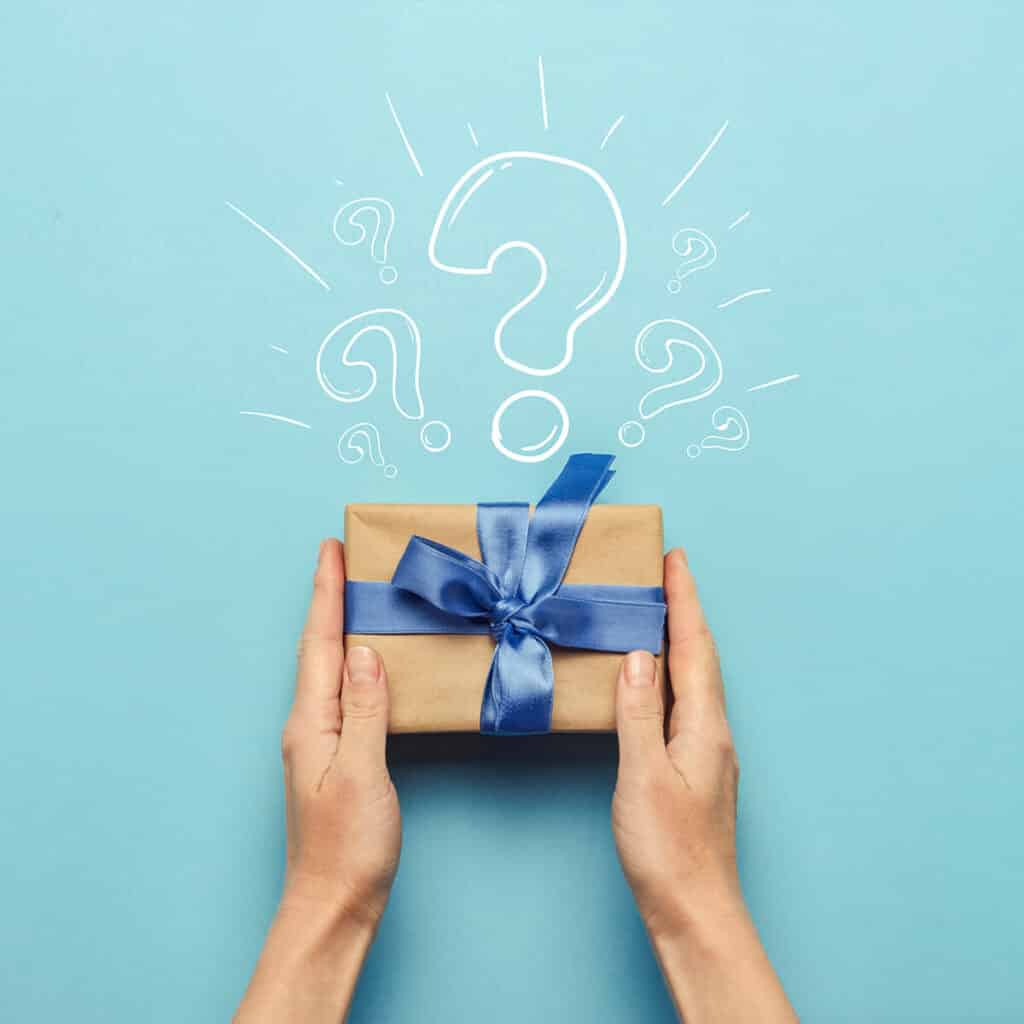 Two hands holding a hostess gift on a blue background with a question mark above it.