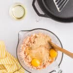 eggs and breadcrumbs in a clear bowl with canned salmon