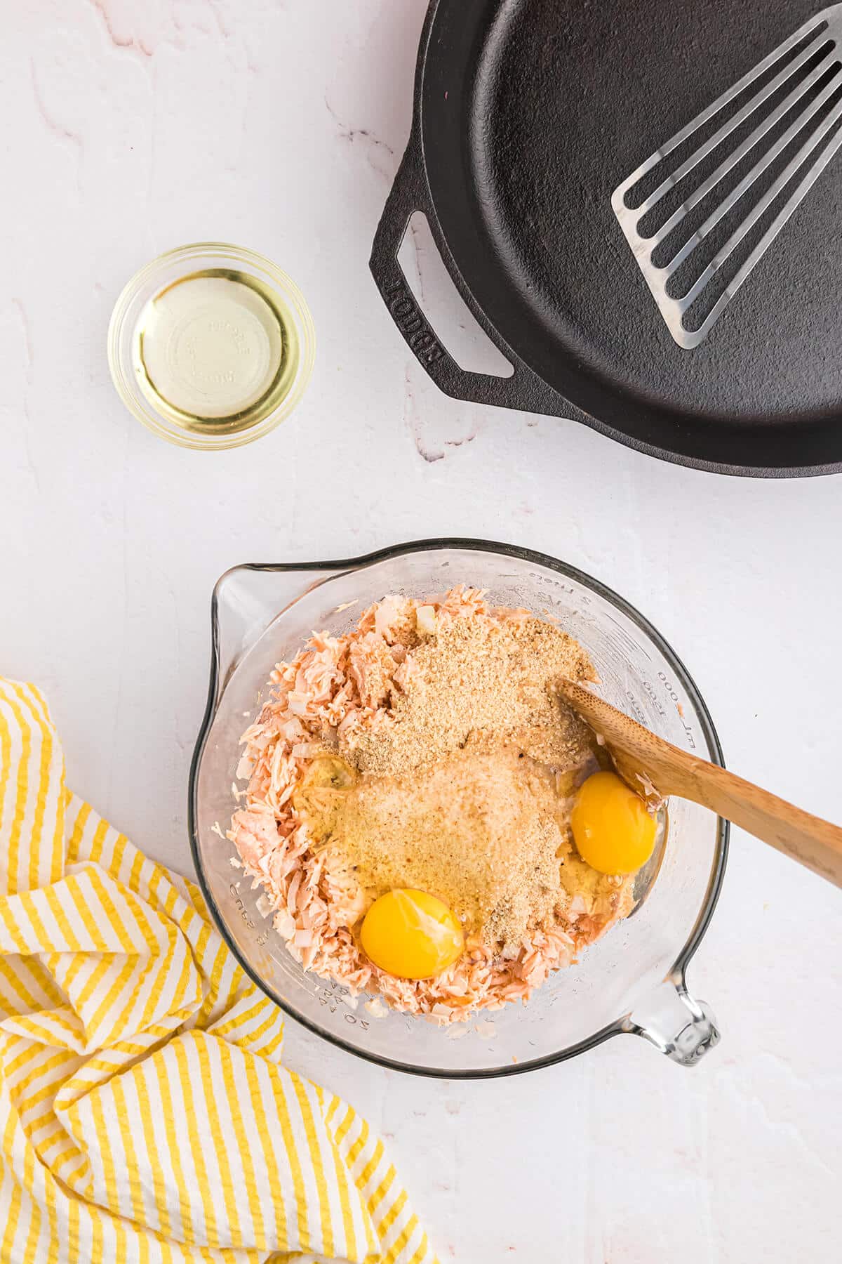 eggs and breadcrumbs in a clear bowl with canned salmon
