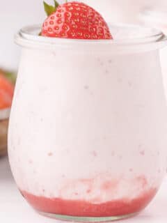 jar filled with strawberry mousse with a strawberry on top