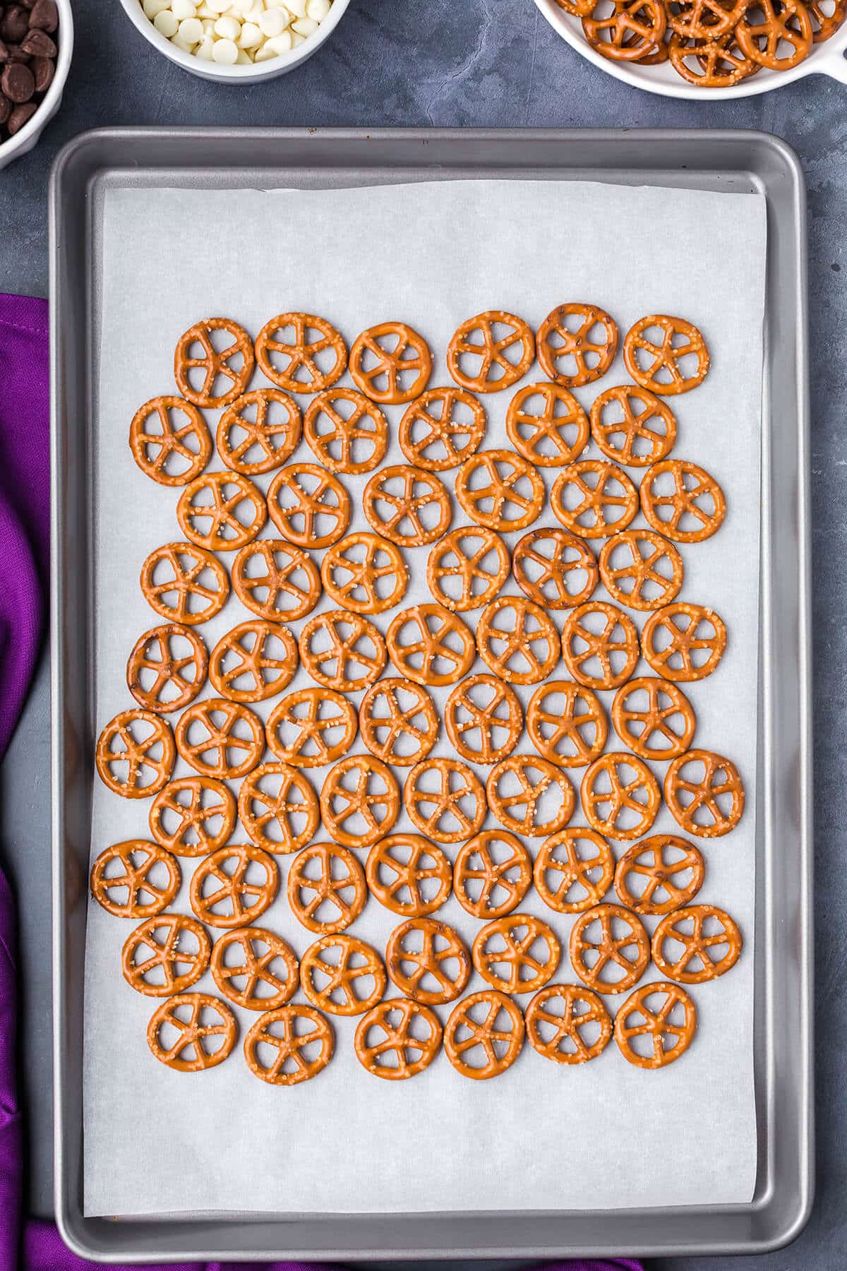 pretzels on parchment paper on a baking sheet