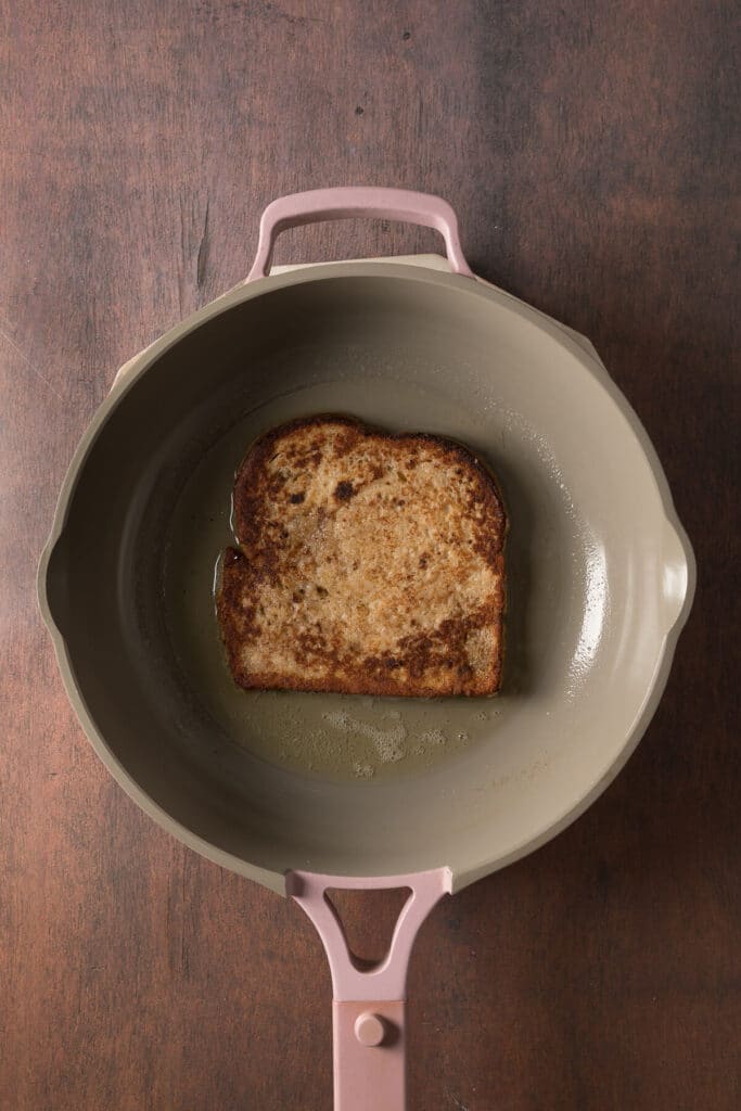Frying French toast in a skillet.