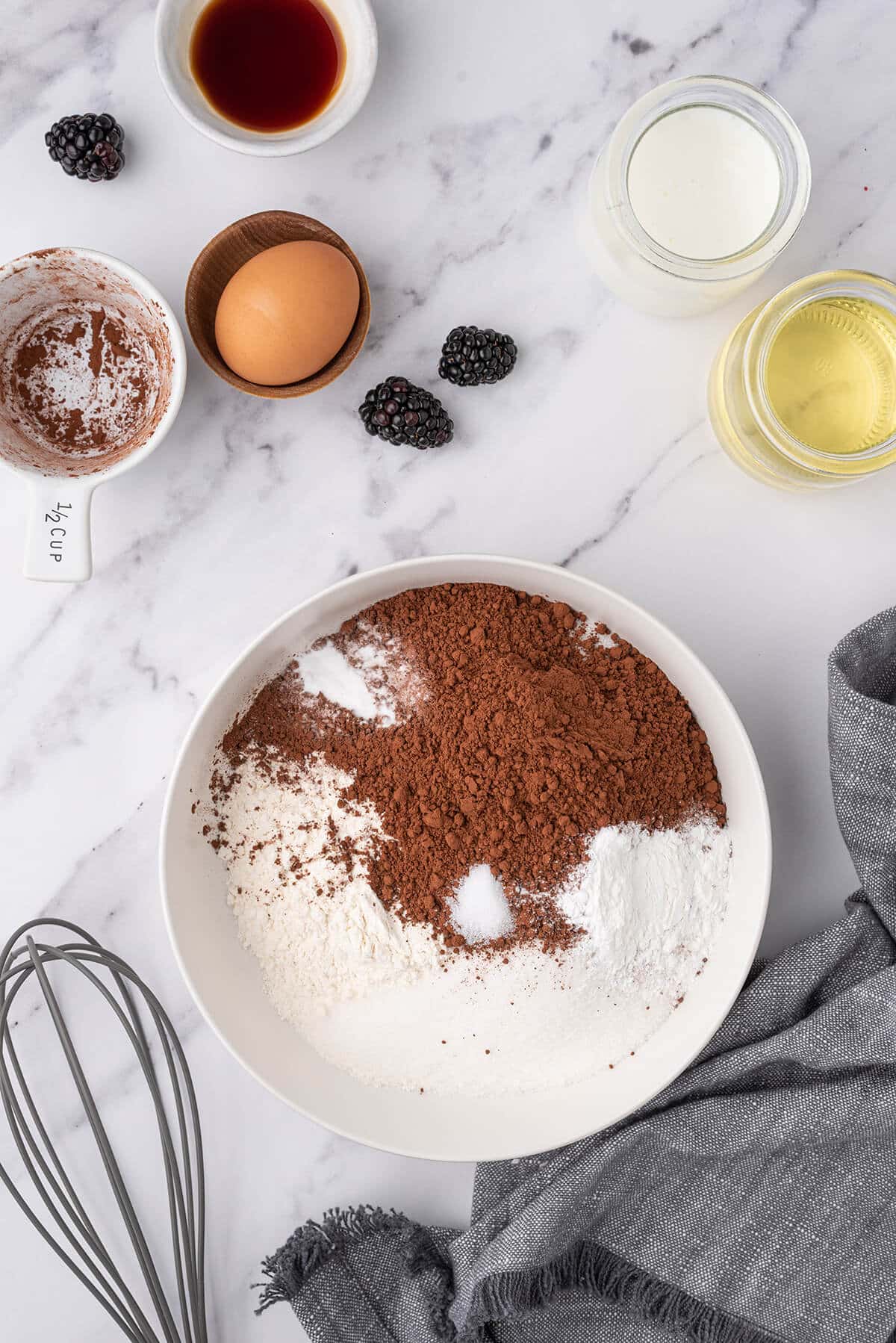 flour and cocoa and sugar combined in a white bowl.