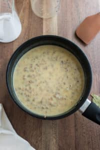 Finished giblet gravy in a black pot.