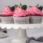 chocolate cupcakes on a white cake stand.