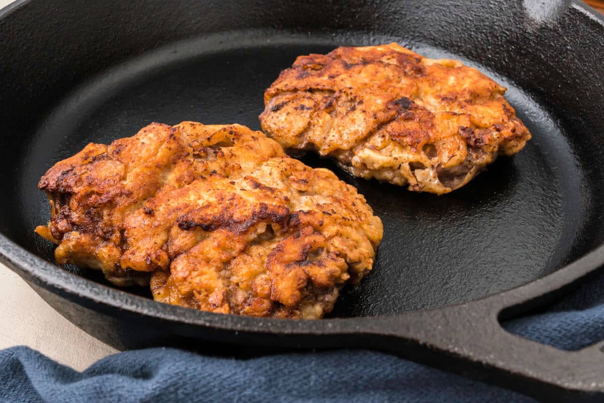 Cast iron skillet with country fried steak.