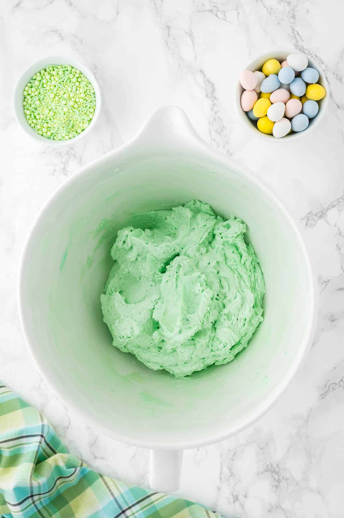 A bowl of green buttercream frosting.