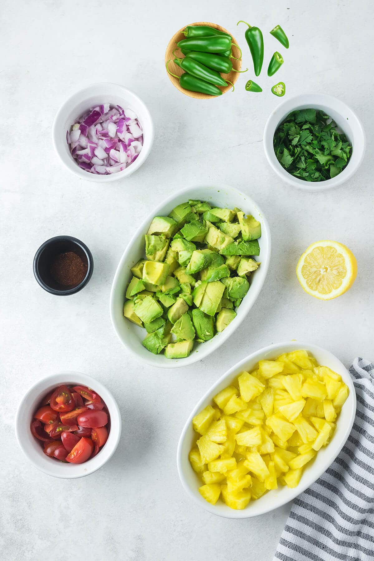 ingredients in bowls on a cutting board.