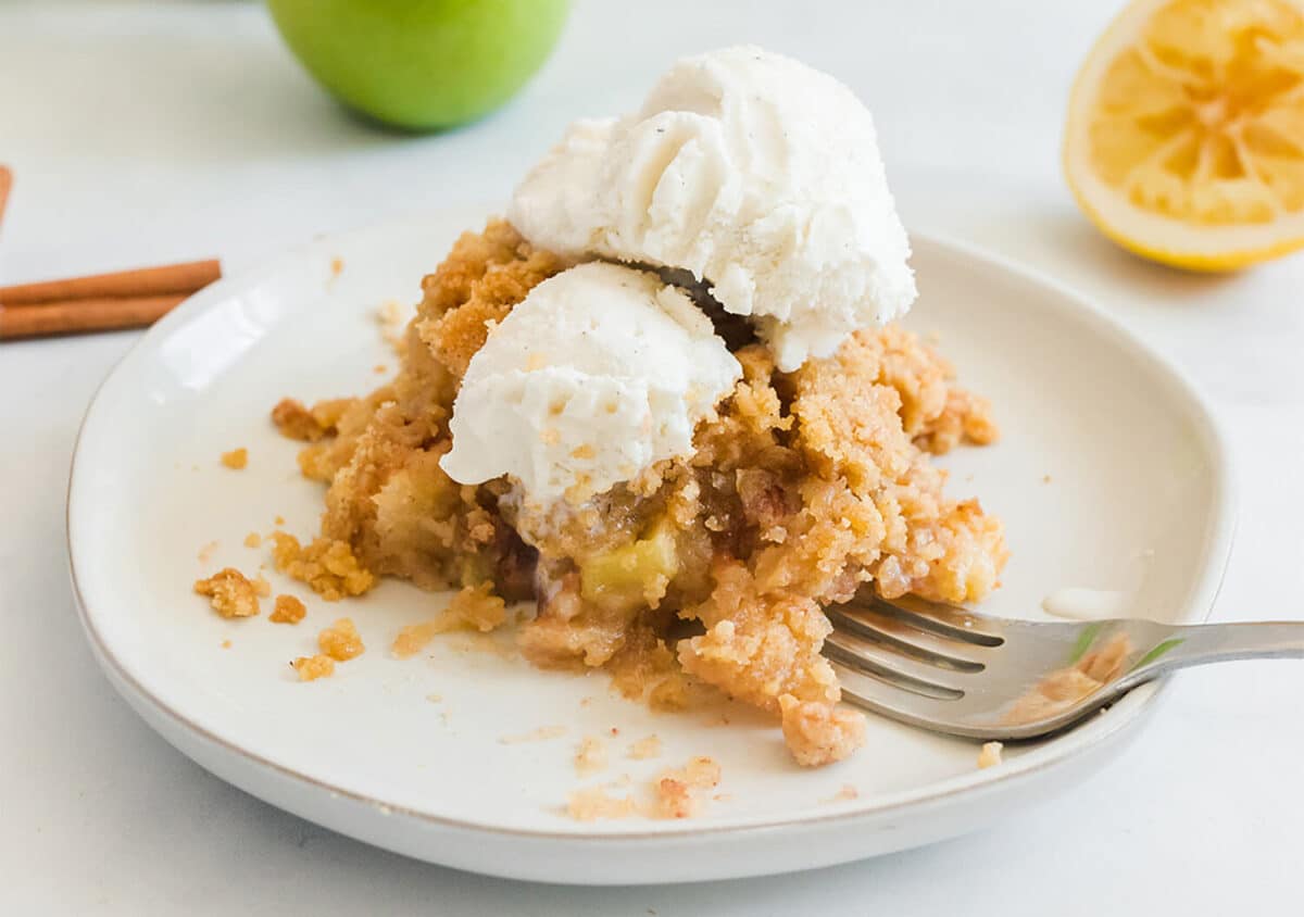 Serving of apple crisp on a plate.