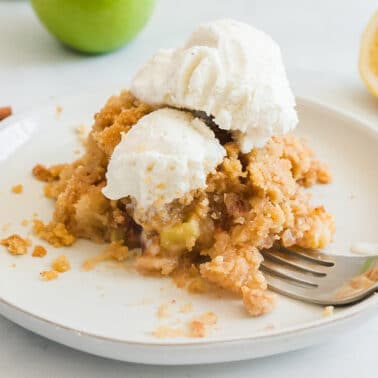 Serving of apple crisp on a plate.