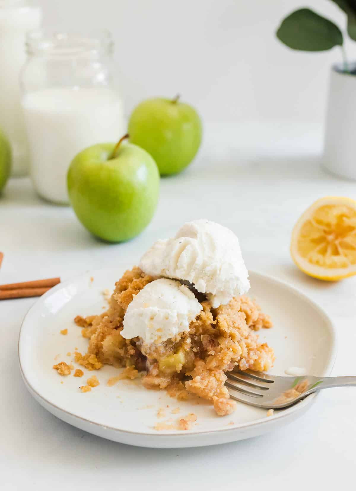 Serving of apple crisp without oats with vanilla ice cream.