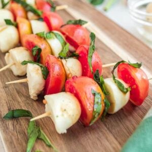 Caprese skewers on a cutting board.