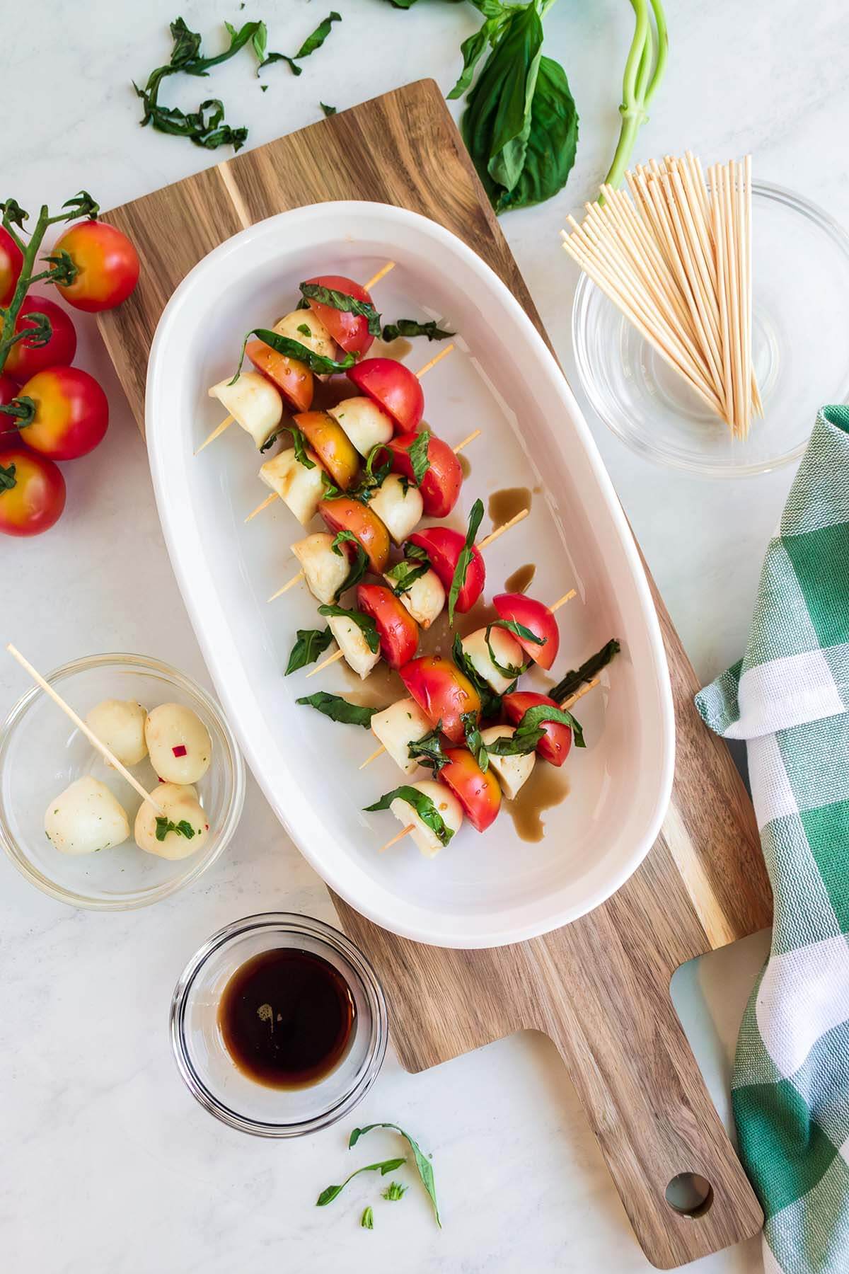 white plate with caprese skewers.