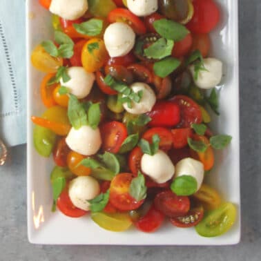 Cherry tomato salad on a white platter.