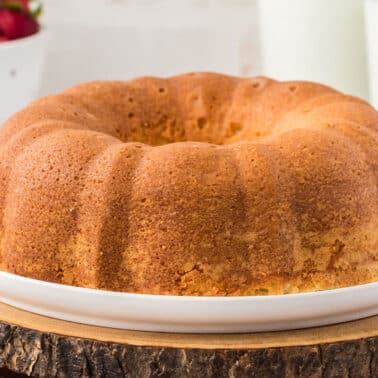 A whole cream cheese pound cake on a platter.