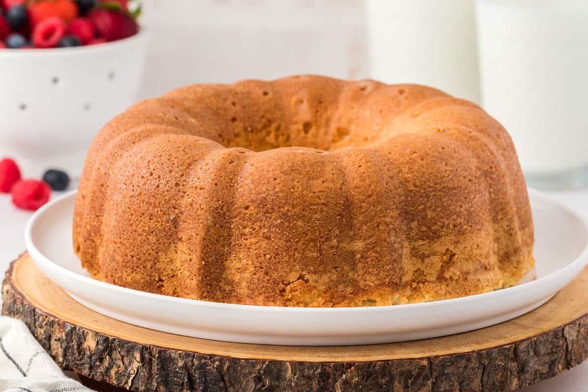 A whole cream cheese pound cake on a platter.