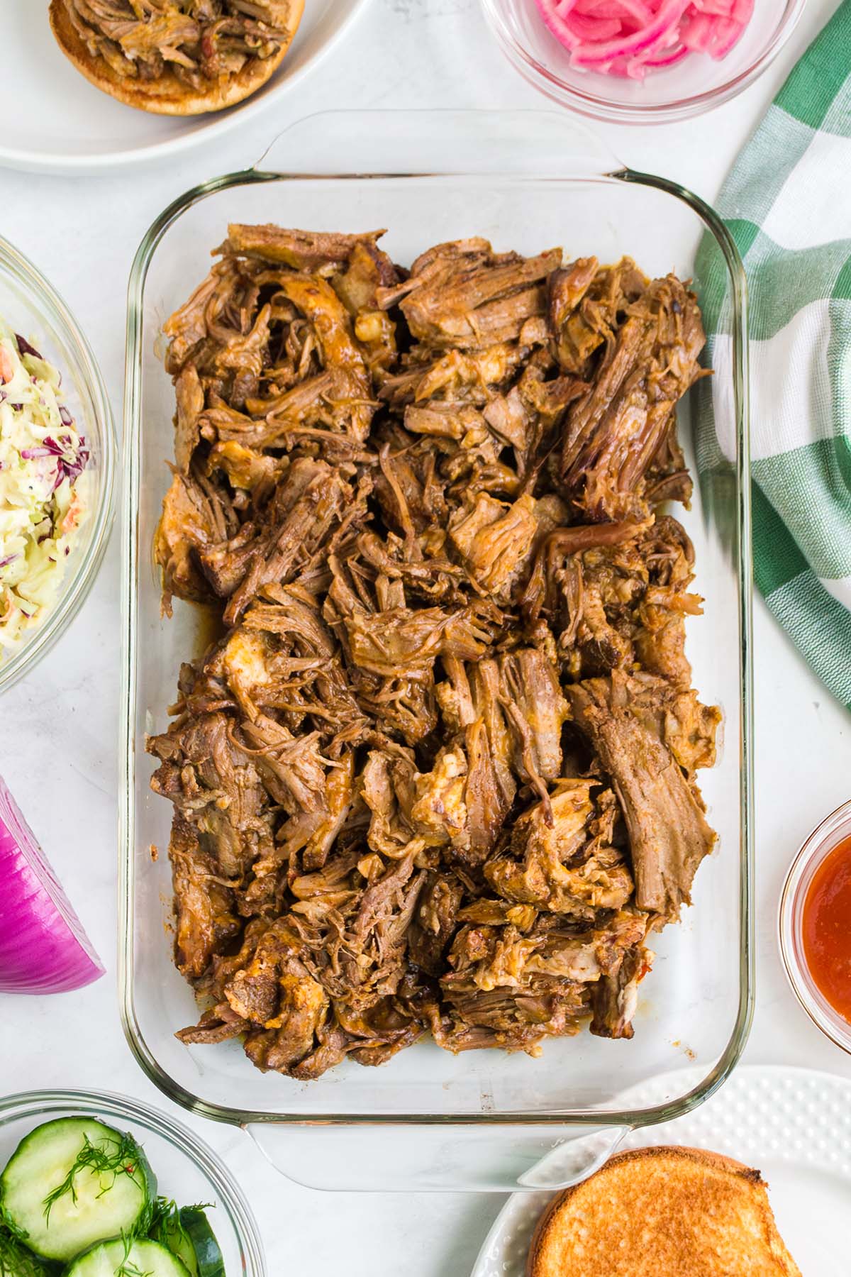 Pulled pork in a clear dish.