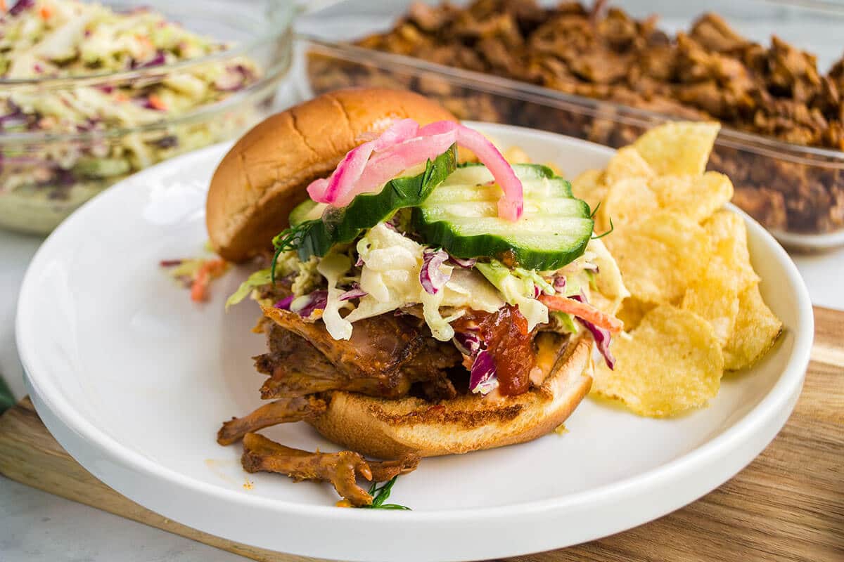 Pulled pork sandwich with slaw and pickles.