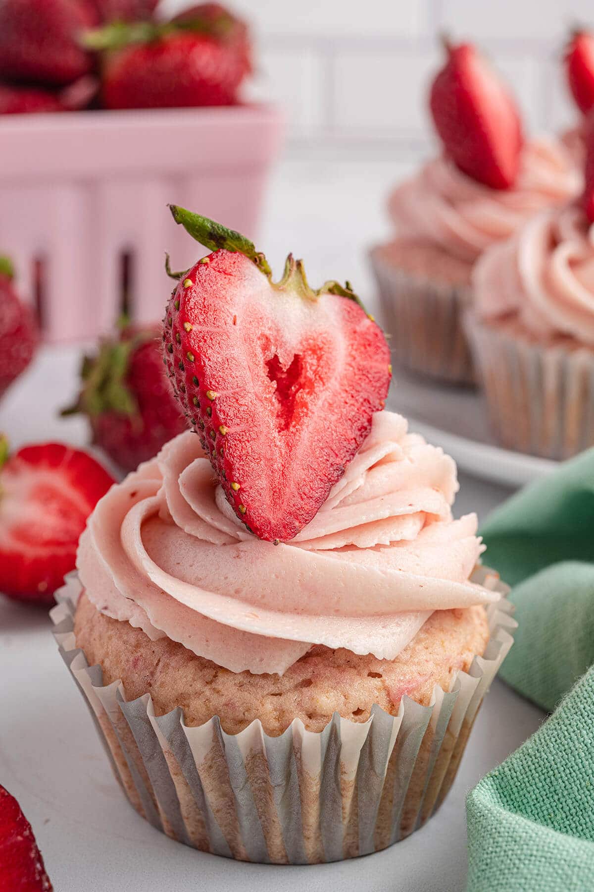 A cupcake with strawberry buttercream icing.