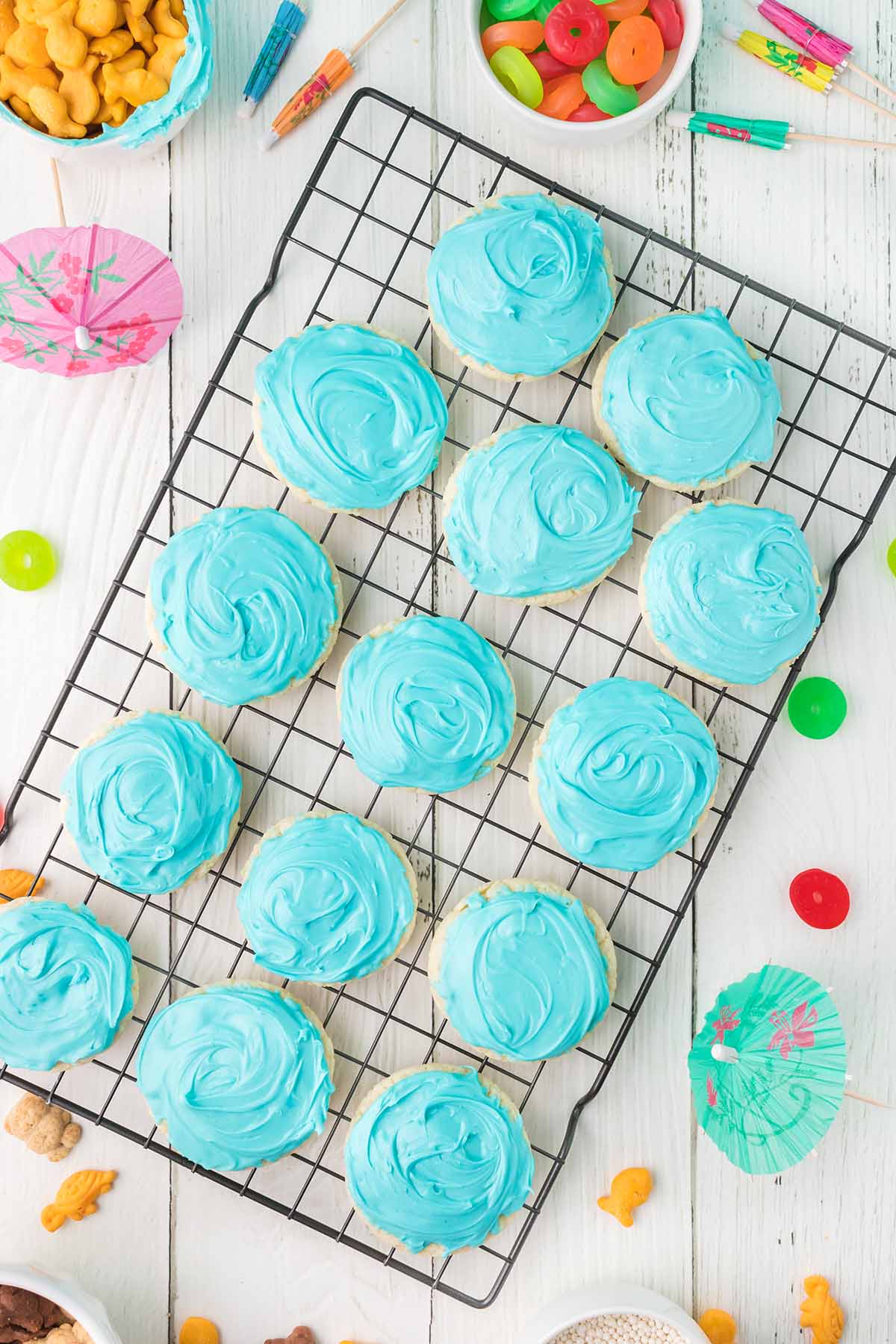 A cooling rack topped with blue frosted cookies.