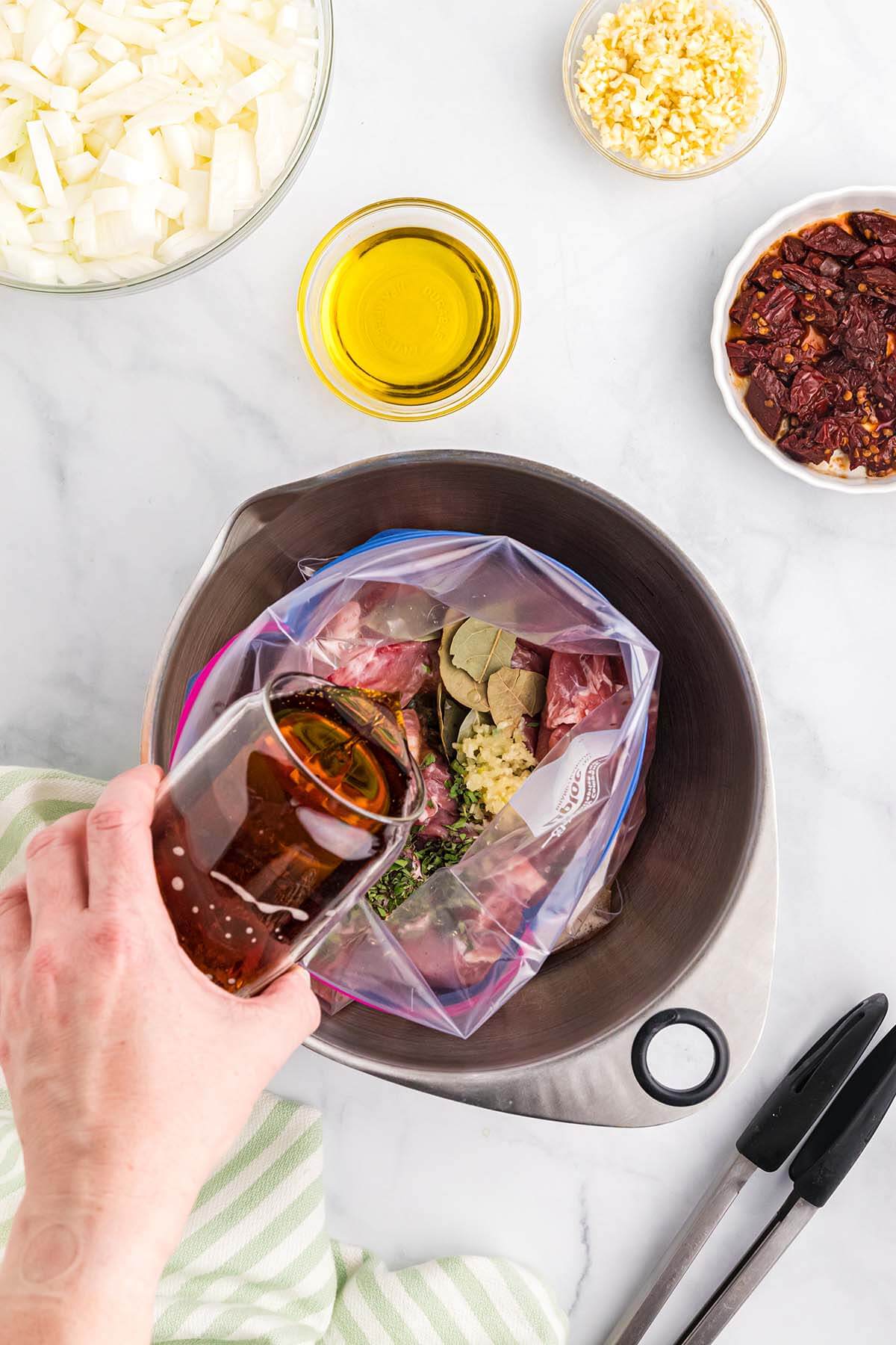 Pouring beer into a bag for marinade.