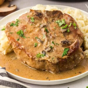 Cream of mushroom pork chop on a plate.