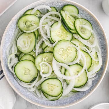 A bowl filled with cucumber onion salad.