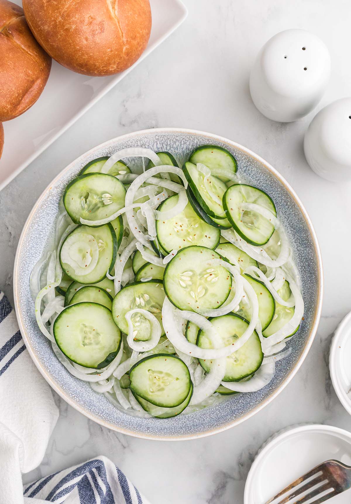 Overhead view of a bowl of cucumber salad.