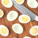 hard boiled eggs on a cutting board.