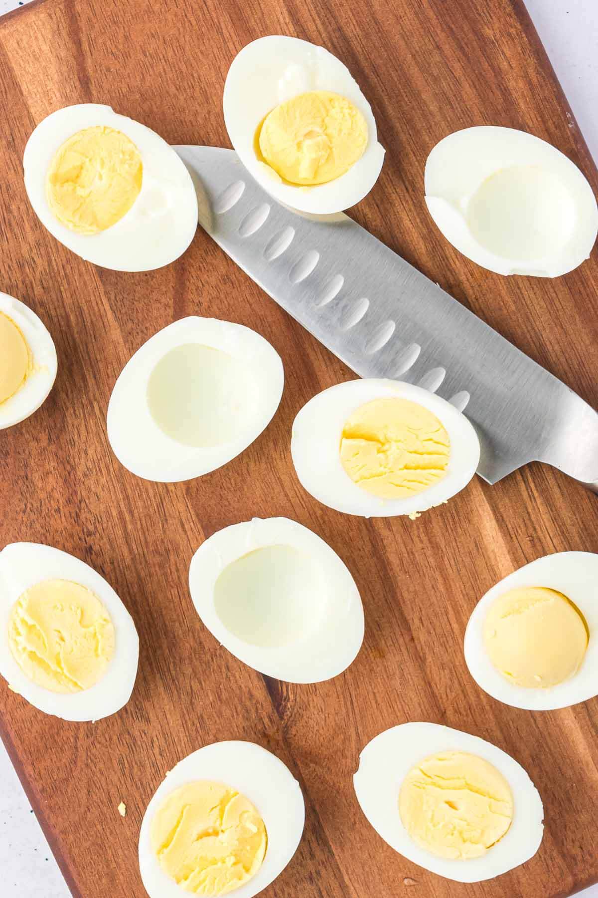 hard boiled eggs on a cutting board.